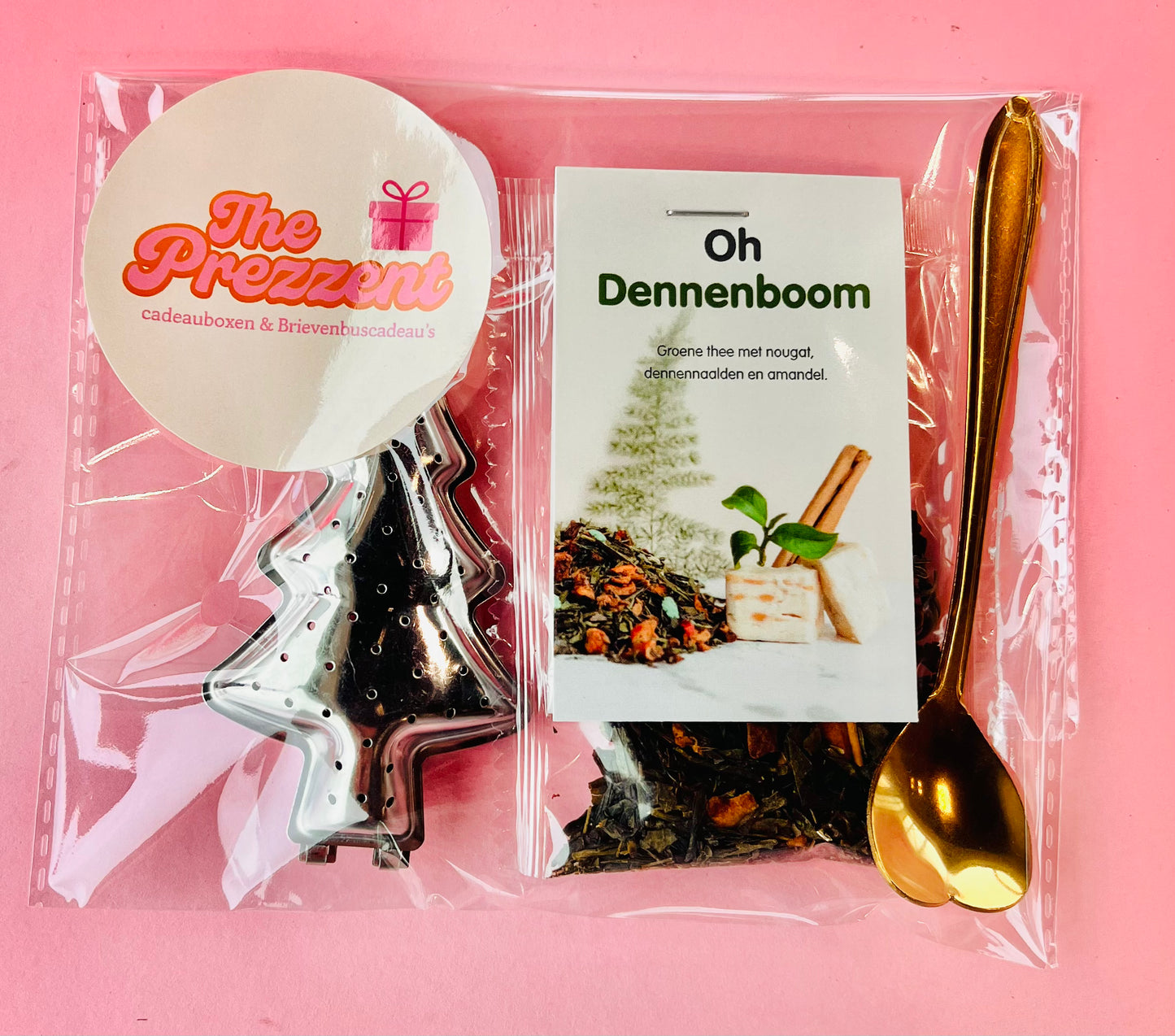 Kerst geschenk zakje met Oh Dennenboom losse thee, kerstboom thee-ei en gouden hartjes lepel in feestelijke verpakking.
