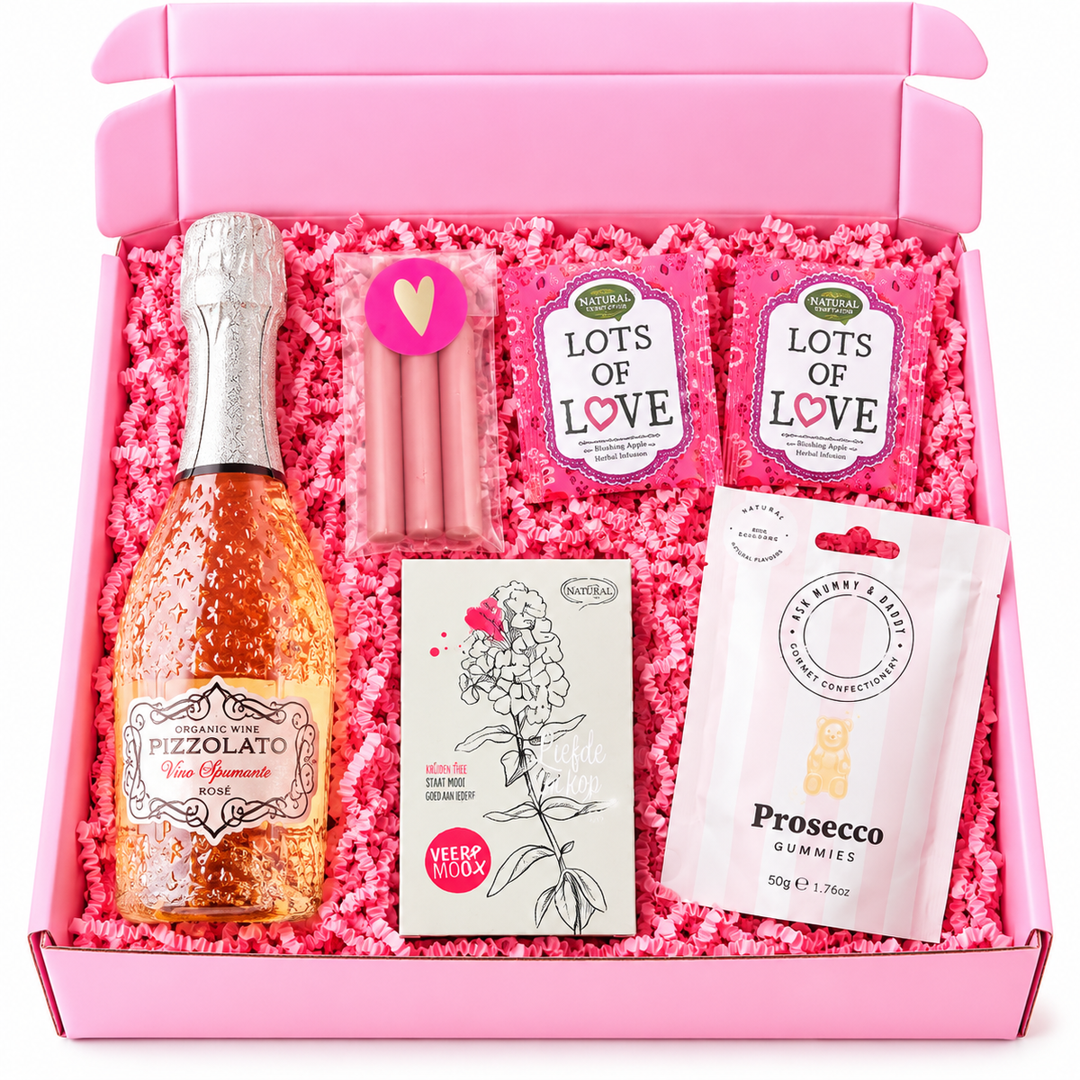 Feestelijke roze verjaardagscadeaubox met rosé bubbels, prosecco-gummies, roze kaarsjes, liefdesthee en roze opvulmateriaal.
