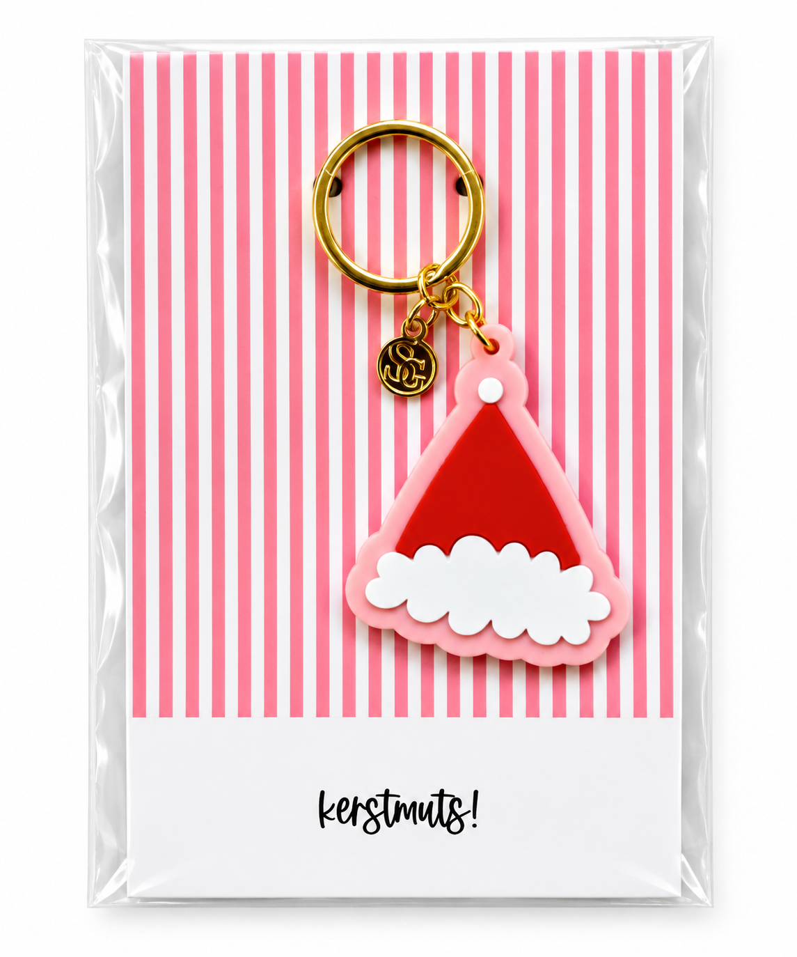 Kerstmuts sleutelhanger in rood en roze met goudkleurige sleutelring op feestelijke kerstkaart
