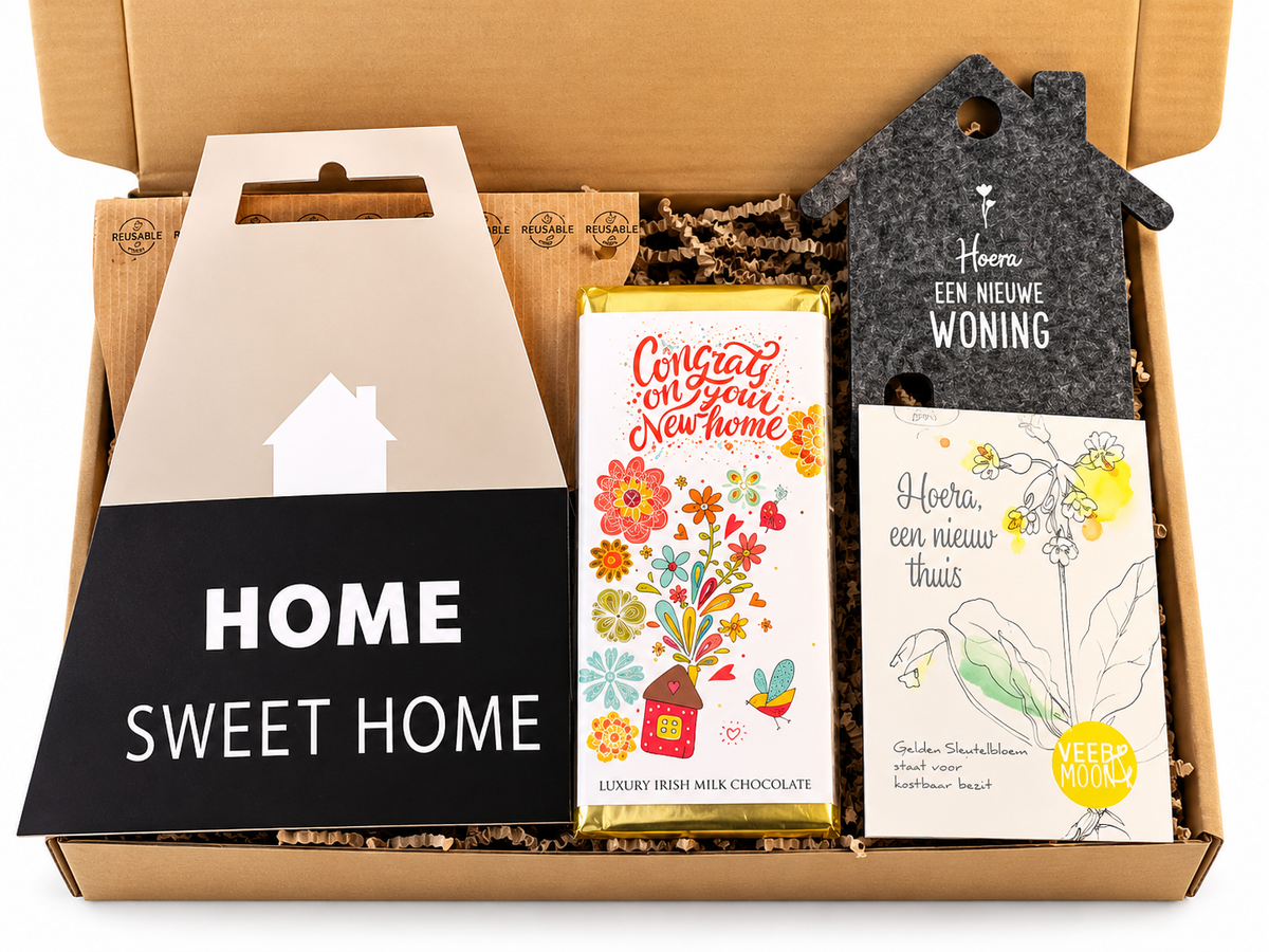 Nieuwe woning cadeaubox met Home Sweet Home decoratie, chocolade en cadeau voor een nieuw huis